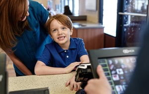 boy-ordering-at-check-out-counter
