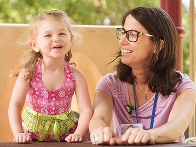 girl with autism with trainer at marcus playground