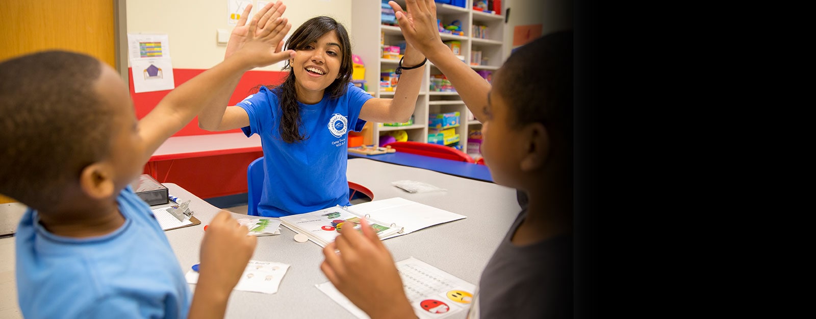 therapist high fiving two patients