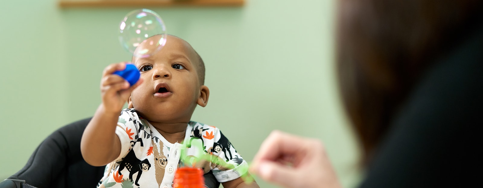 small boy playing with bubbles at marcus autism center