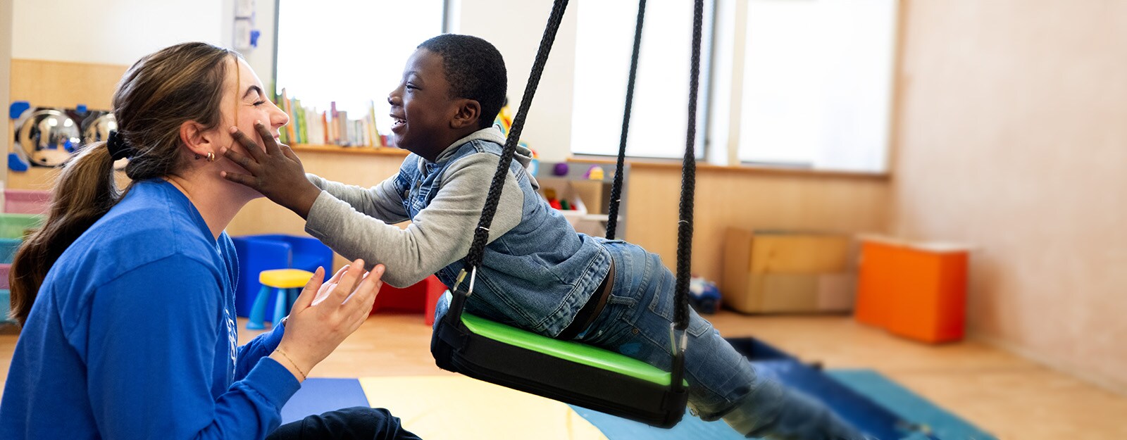 therapist with patient on swing