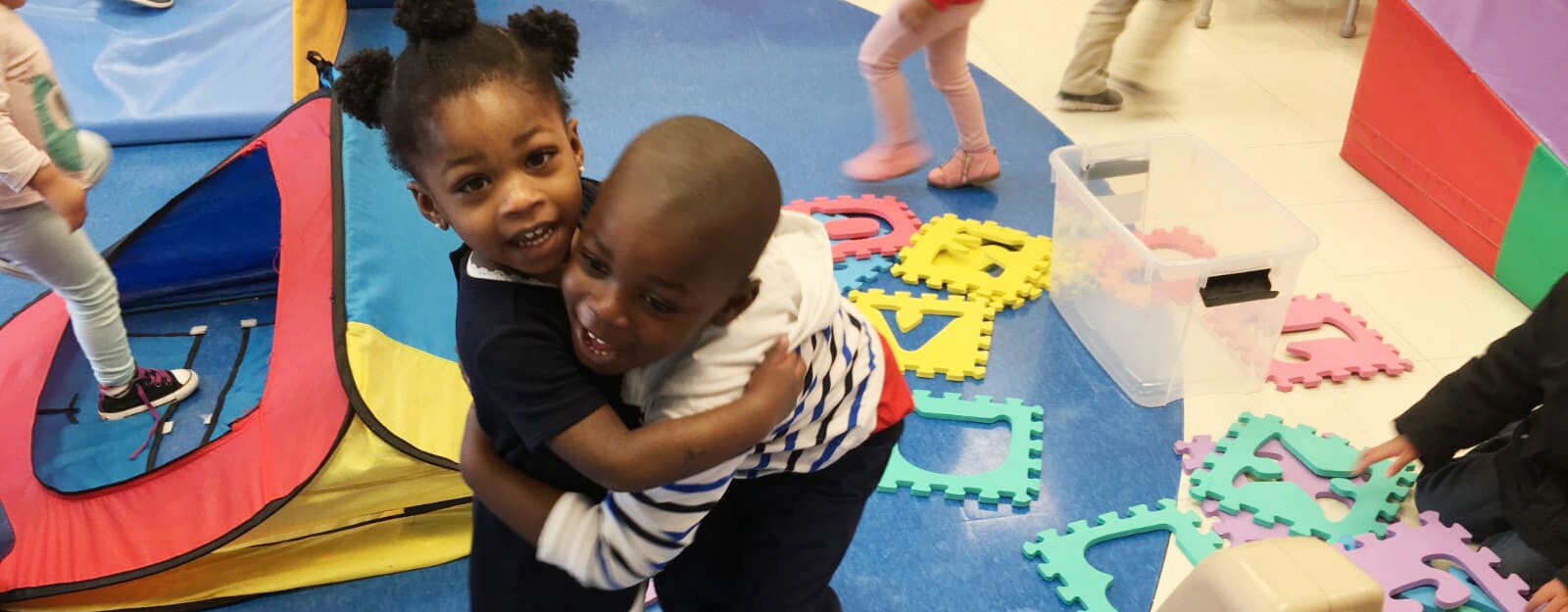 boy and girl hugging in preschool