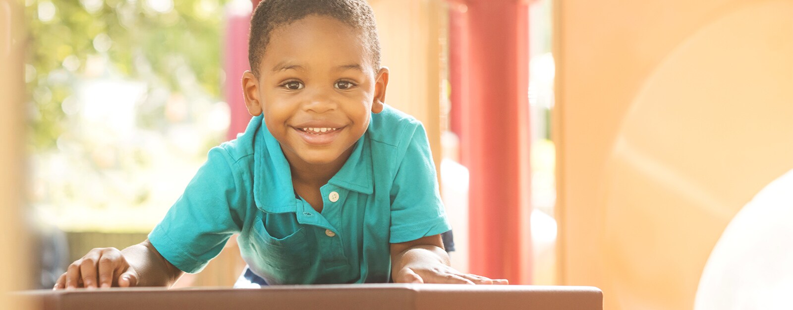 boy smiling at camera on marcus autism center playground