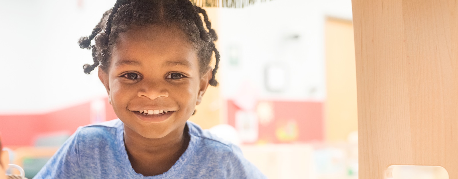 young girl smiling at camera at marcus autism center