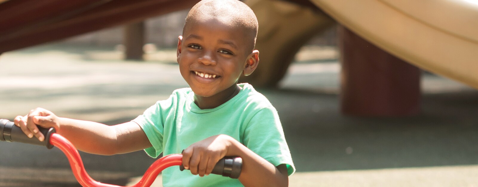african american child on bicycle at marcus autism center
