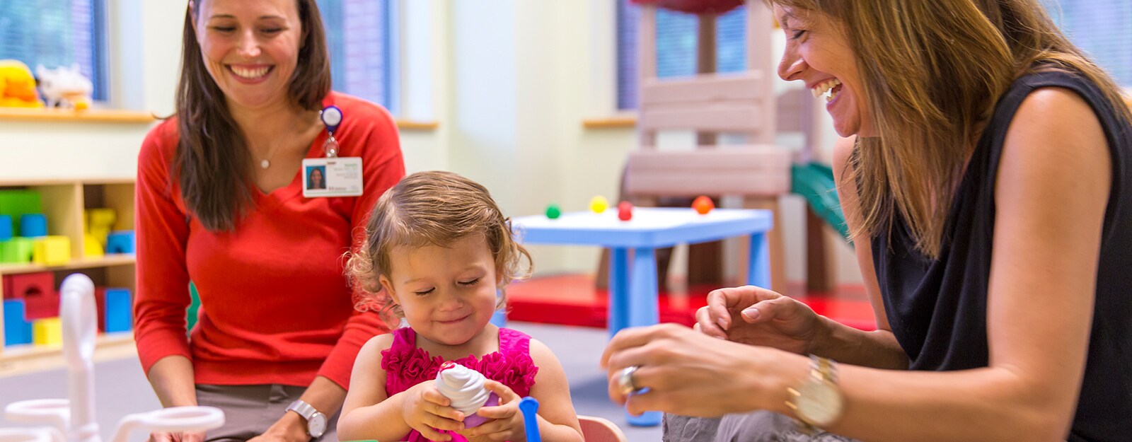 researchers playing with young girl