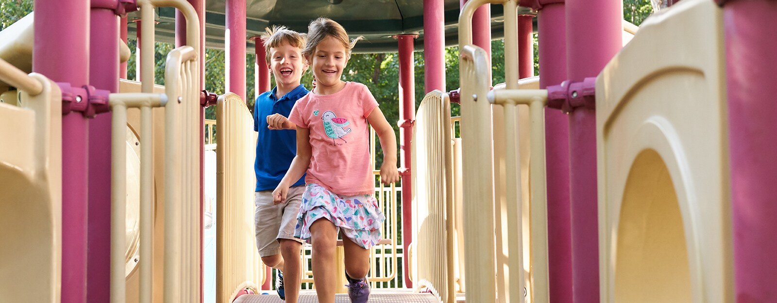 boy girl running on playground